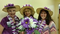 Three ladies in hats and flowers